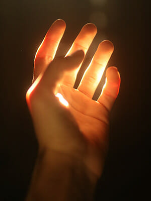 A hand shining with energy